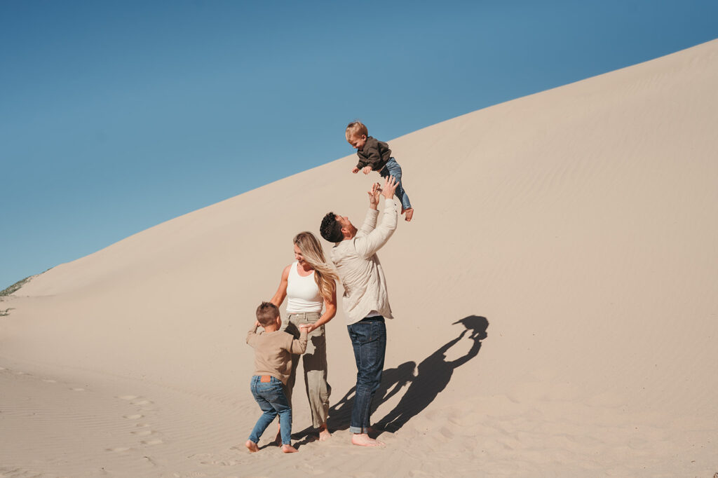 family playing at the beach 