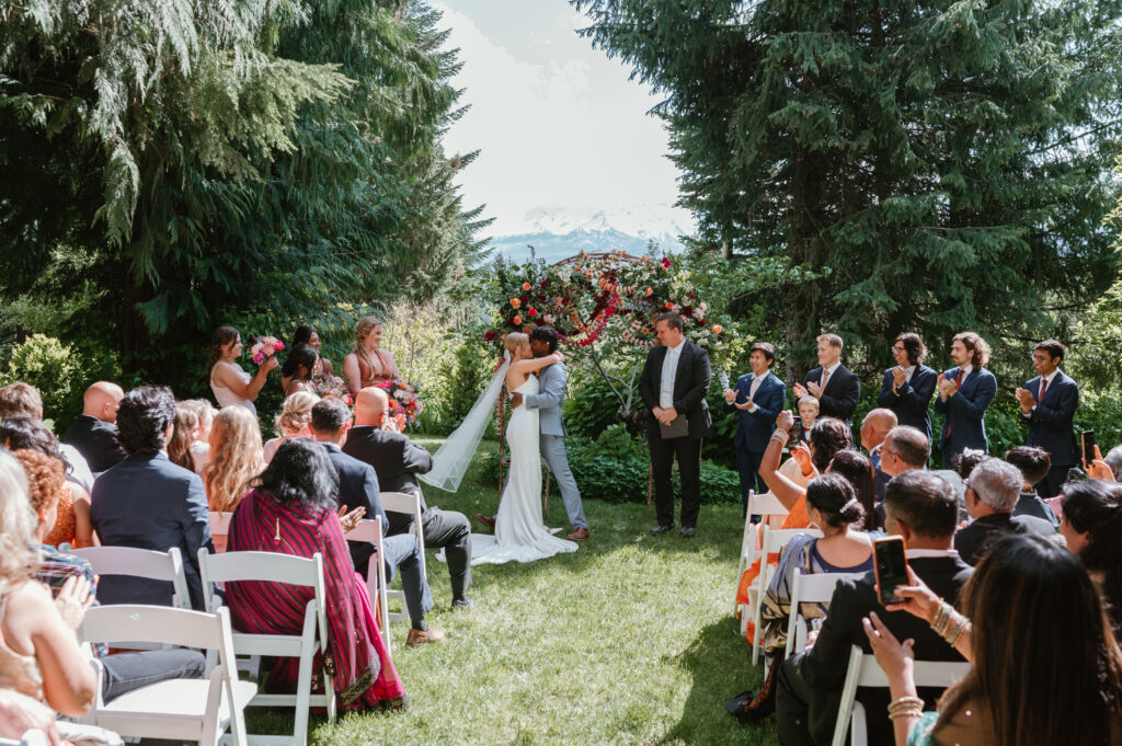 Wedding ceremony where couple is having their first kiss as a married couple in hood river, Oregon