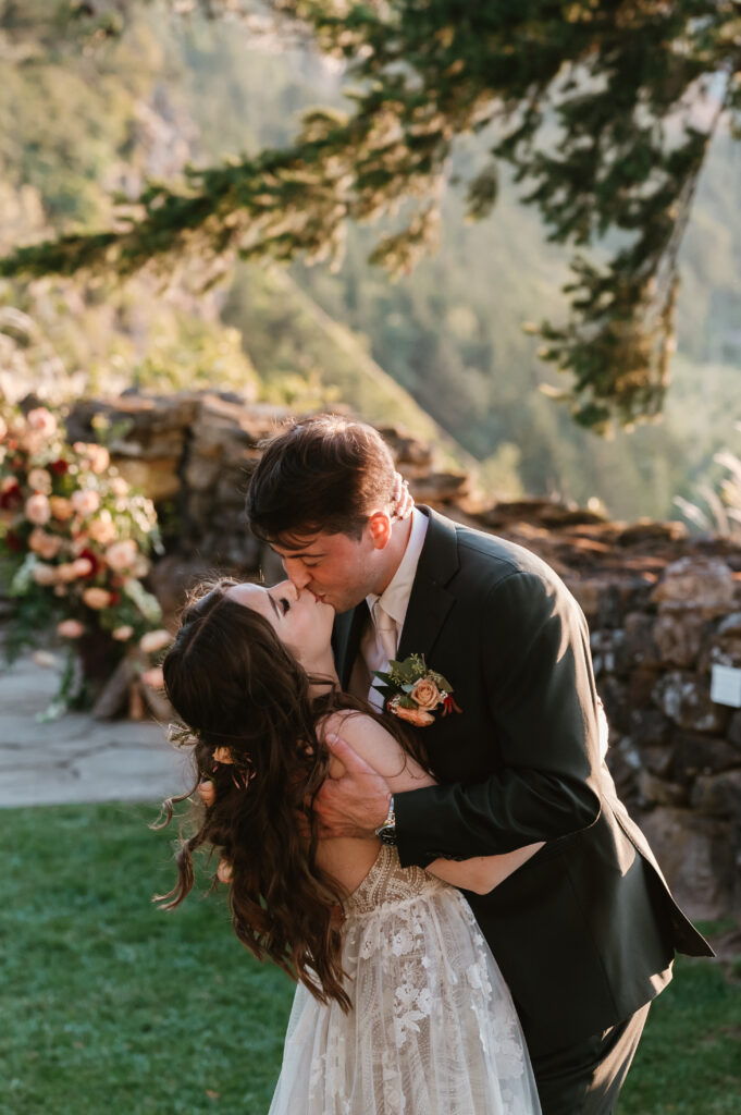 bride and groom kissing and smiling in sunset portraits 