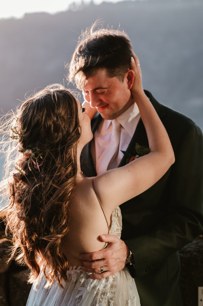 bride looking into grooms eyes and holding his head 