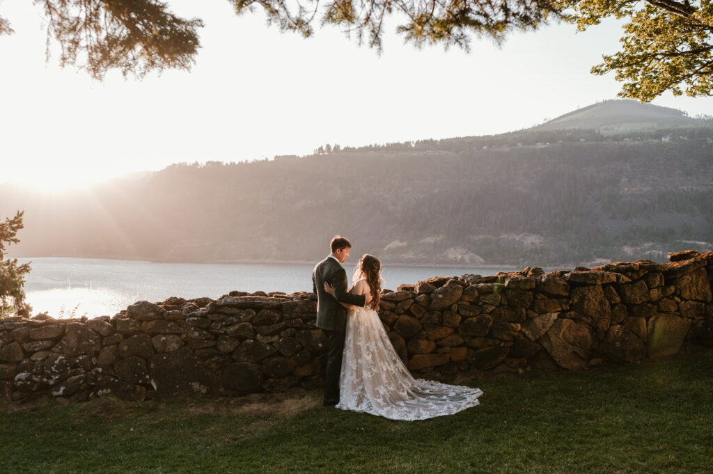 bride and groom holding each other at the cliff overlooking the Columbia River Gorge in Hood River 