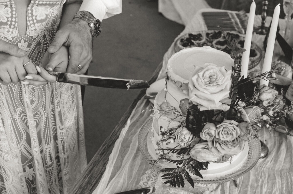 bride and groom cutting the cake 