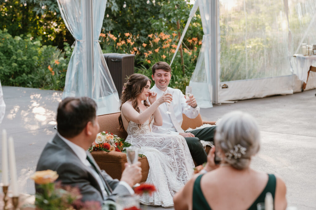 couple crying and toasting at their wedding