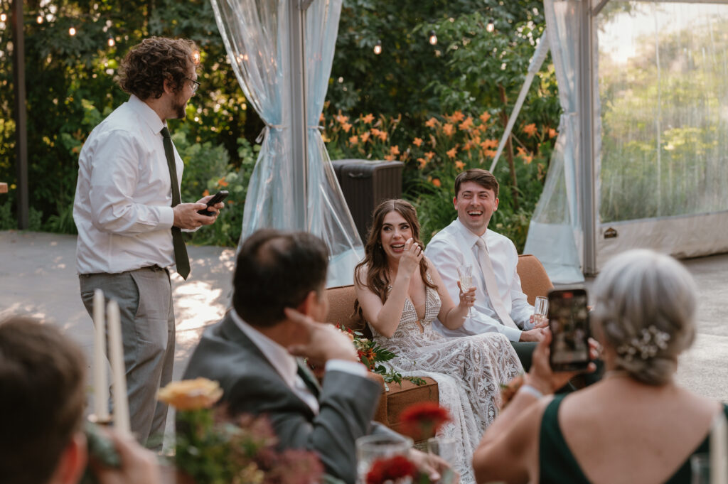 bride crying during brothers speech at wedding reception 