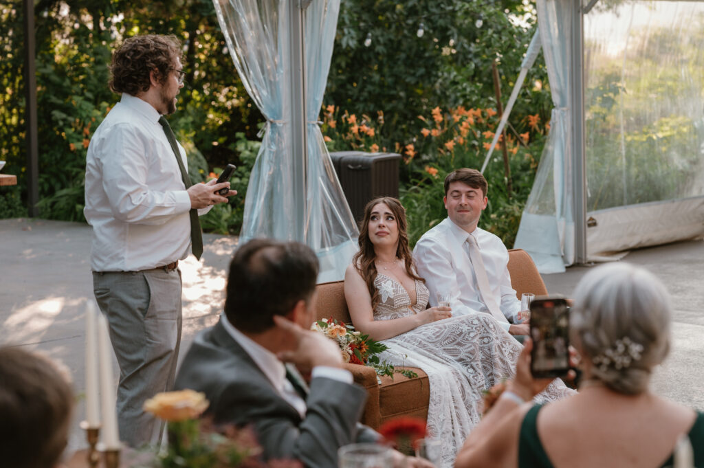 bride getting emotional over toasts at wedding reception 