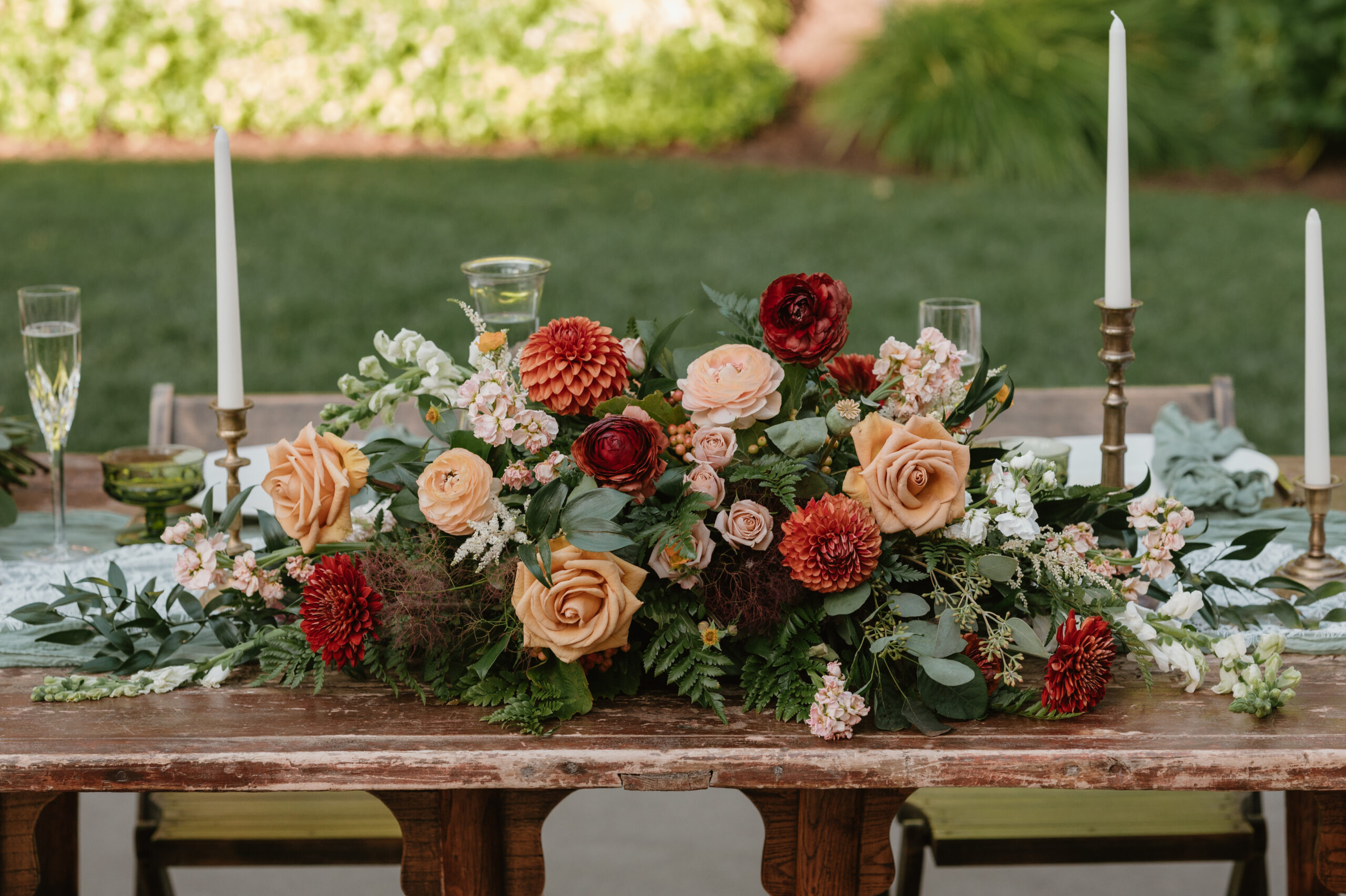 sweetheart table with large centerpiece and taper candles 