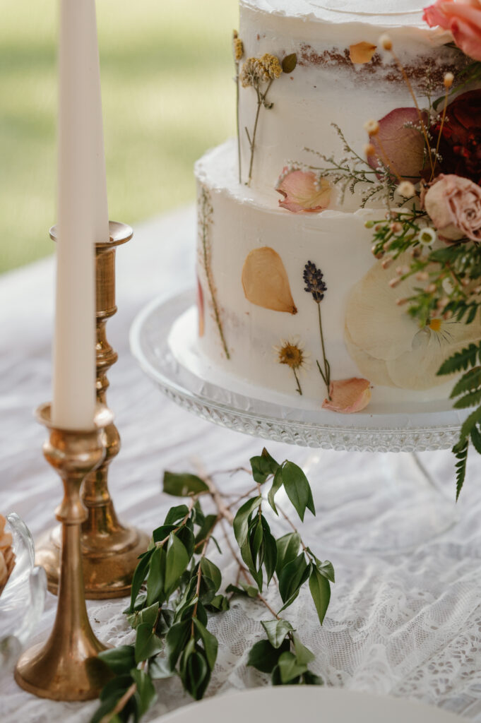 pressed flowers mixed with fresh flowers on a white wedding cake 