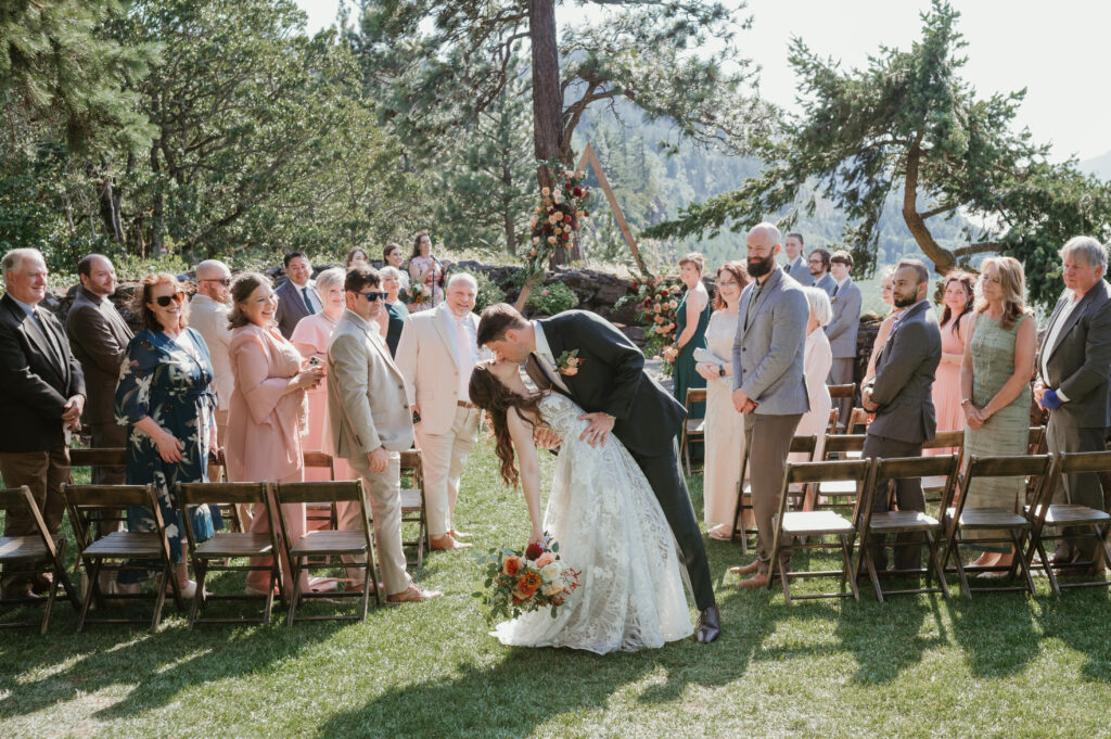 bride and groom kissing and dip in middle of the aisle 