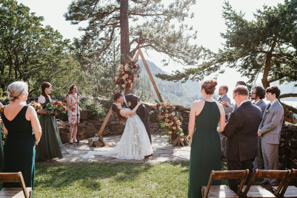 first kiss for bride and groom during wedding ceremony 