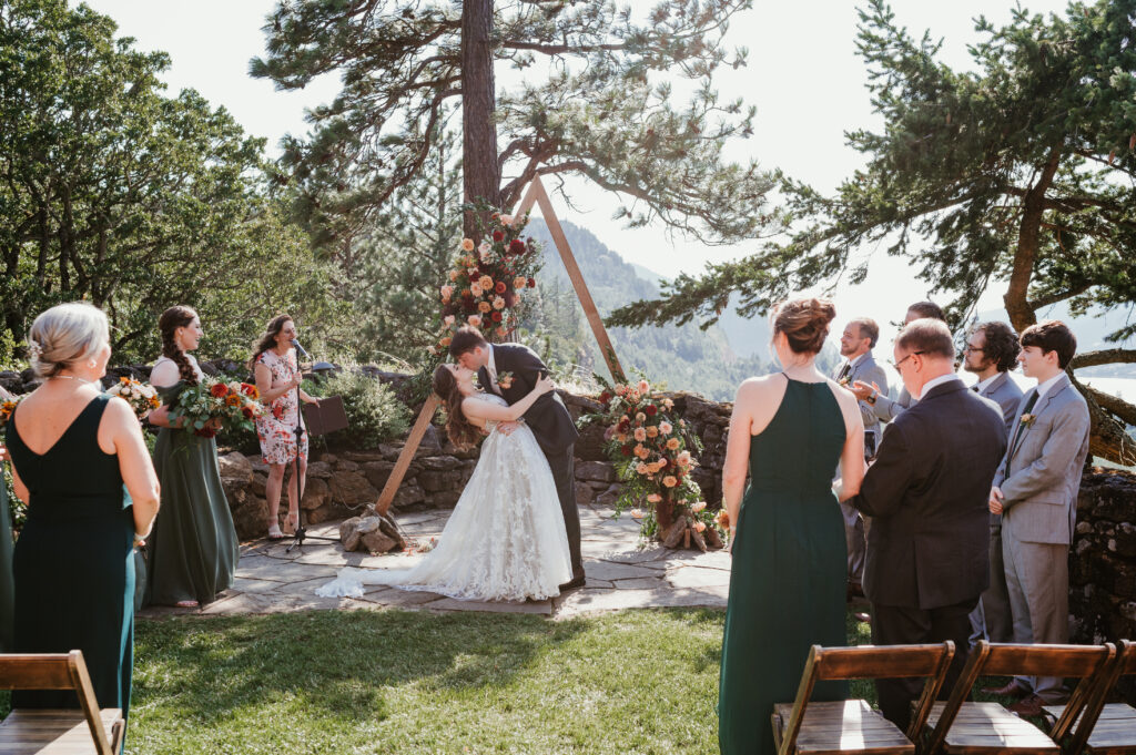 first kiss for bride and groom during wedding ceremony 