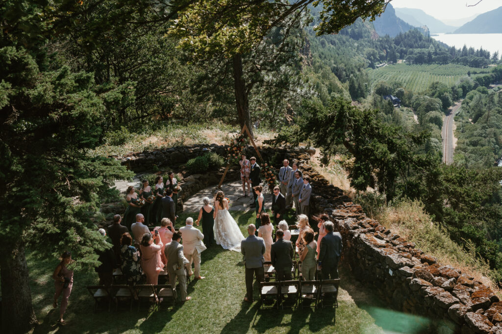 bride walking down the aisle with guests standing around her