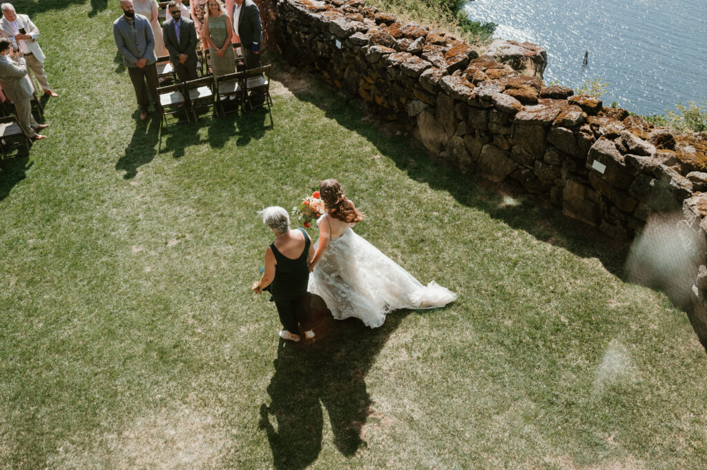 bride walking down the aisle with her mother 