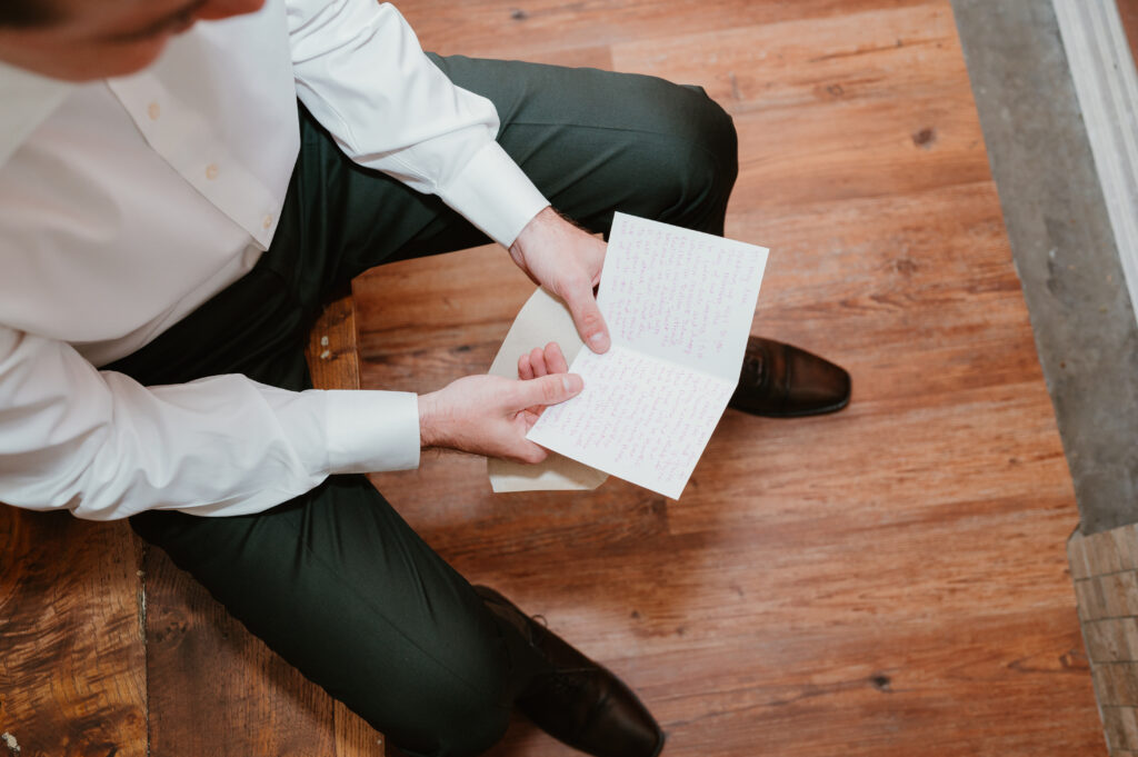 groom reading special gift from bride 