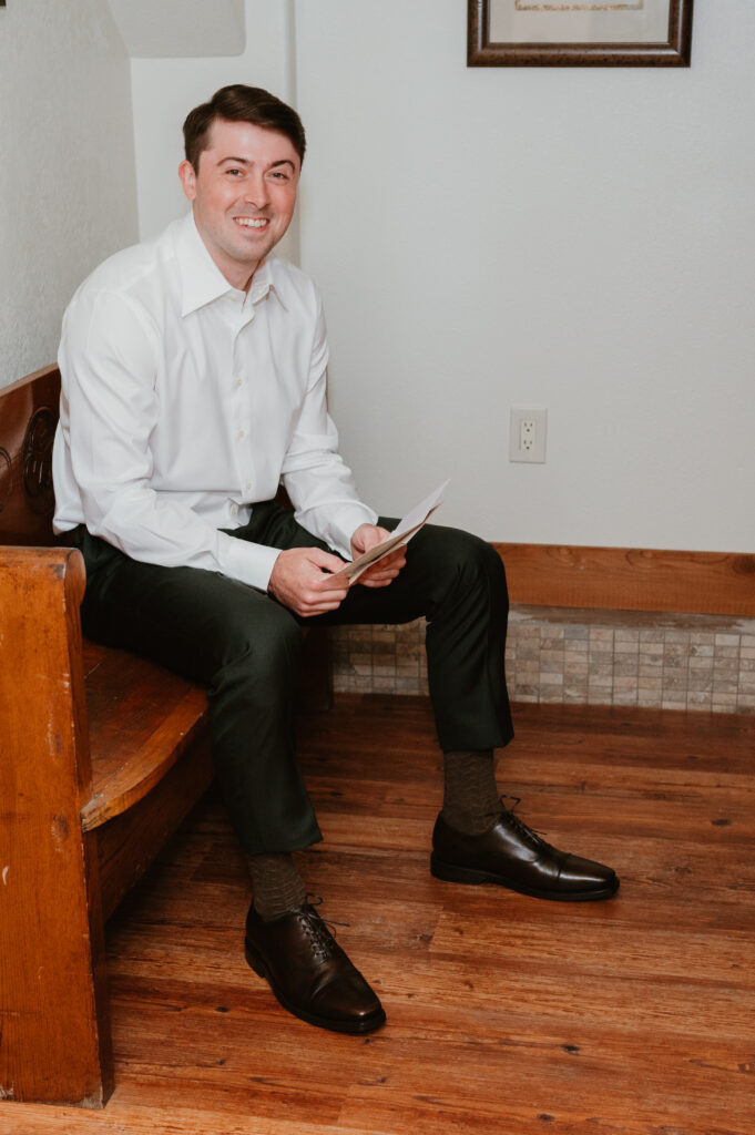 groom smiling at camera at the griffin house 