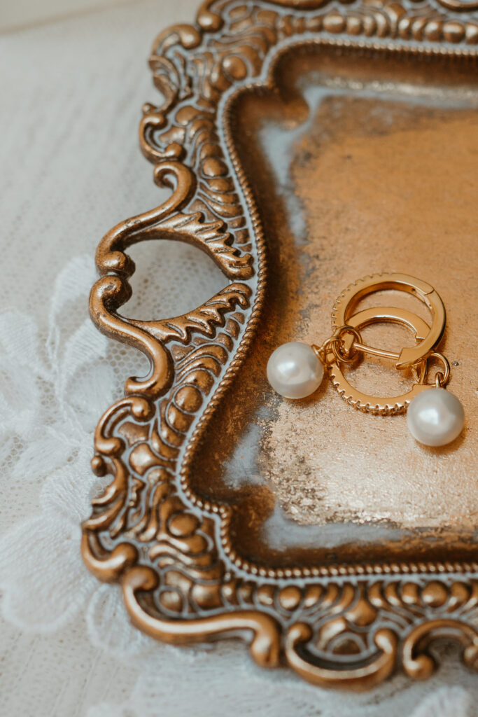 brides earrings on a gold tray 