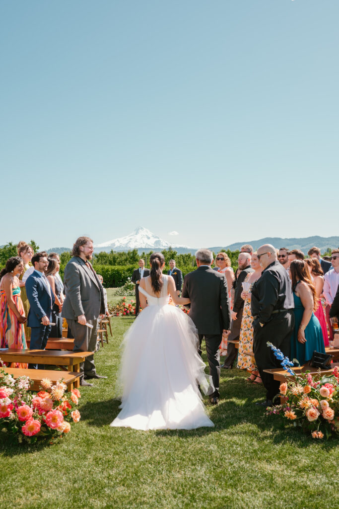 bride walking down the aisle at the Orchard