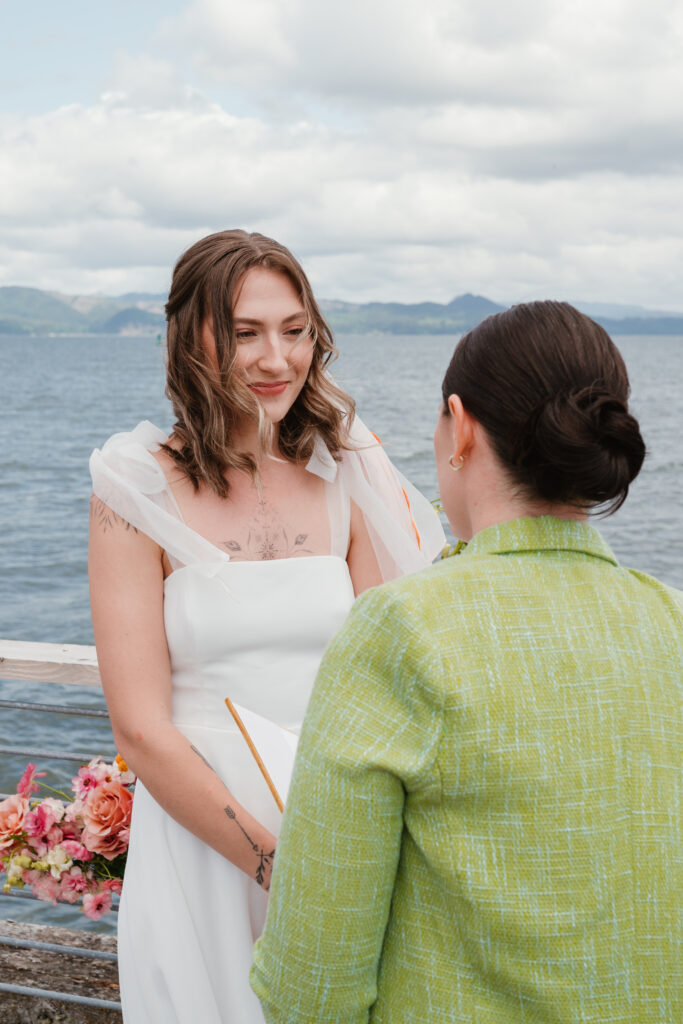 brides saying vows to each other in oregon coast