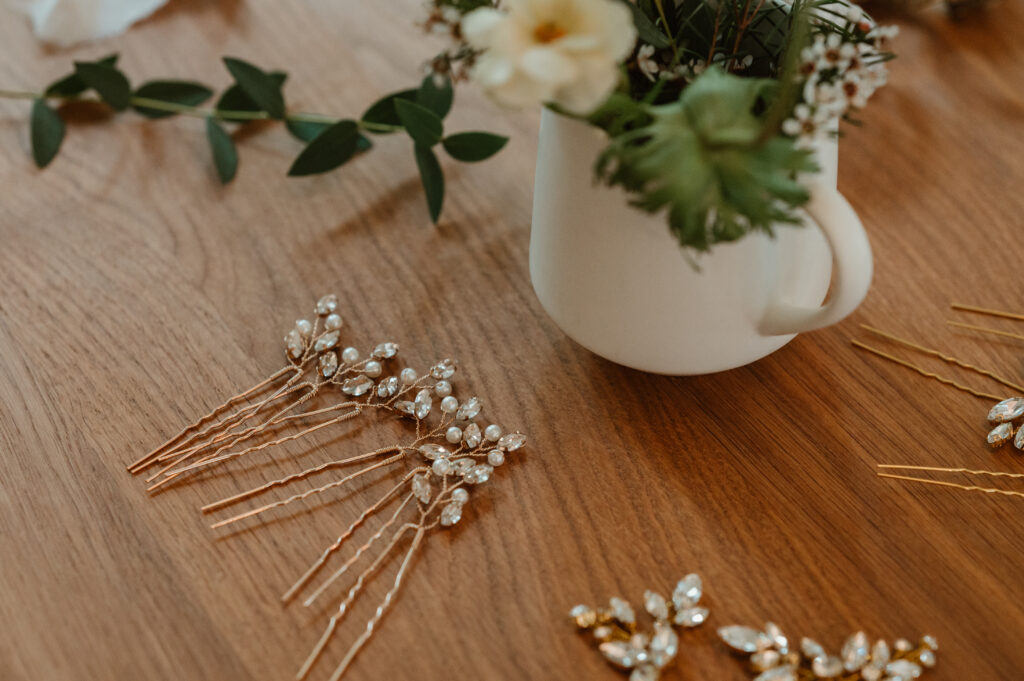 Brides floral hair pins sitting on the table 