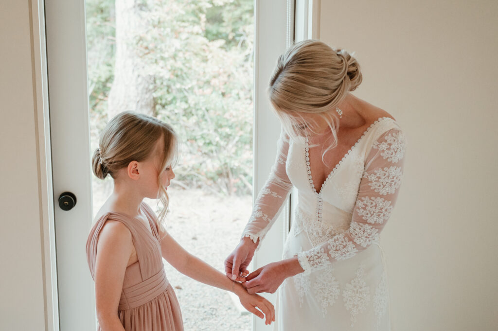 bride helping her daughter with her jewelry 