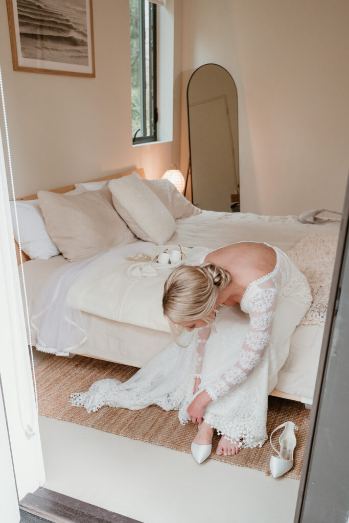 Bride slipping her shoes on as she gets ready for her elopement 