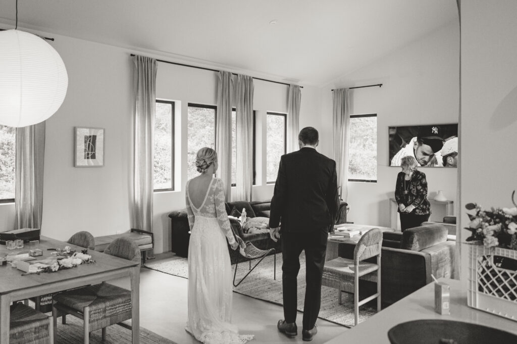 Couple at Meena lodge looking at their family during their intimate oregon coast wedding 