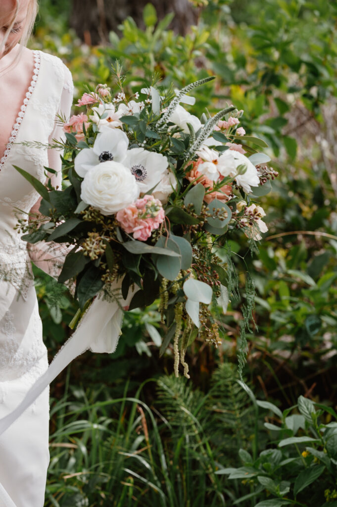 bridal bouquet being held by bride as she walks to her ceremony spot 