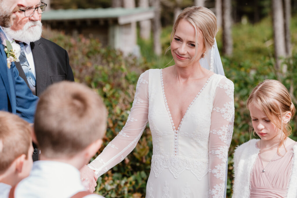 bride smiling at her stepson during the ceremony