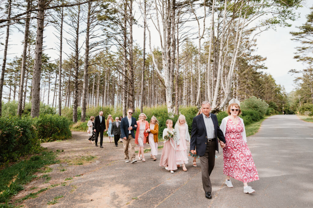 family walking to the next location at their oregon coast wedding 