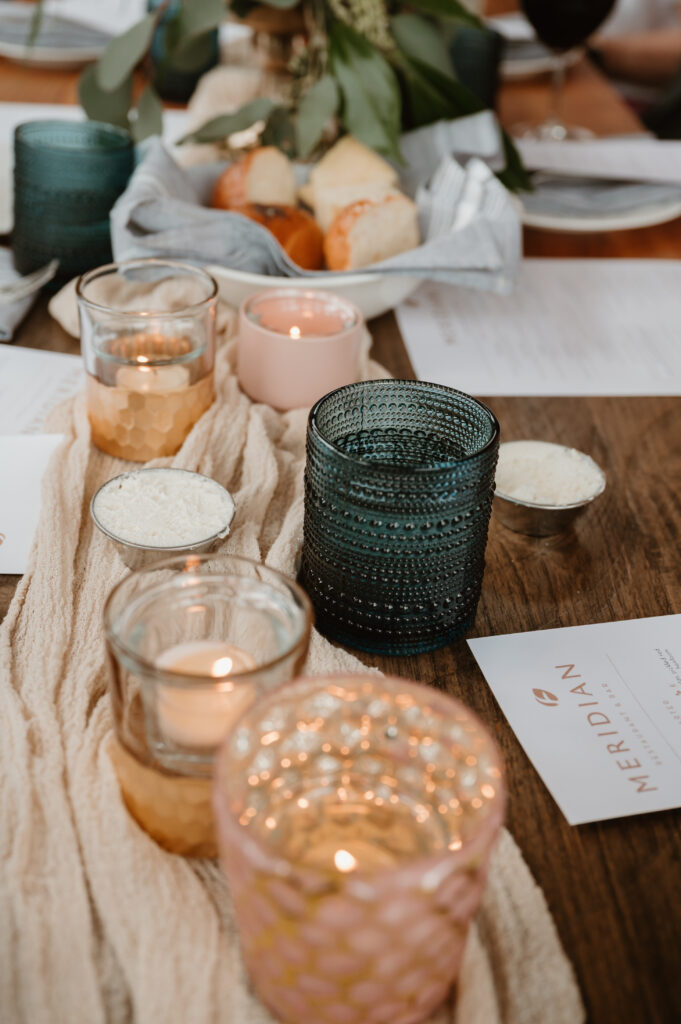 Reception details including candles, glasses, and runner. 