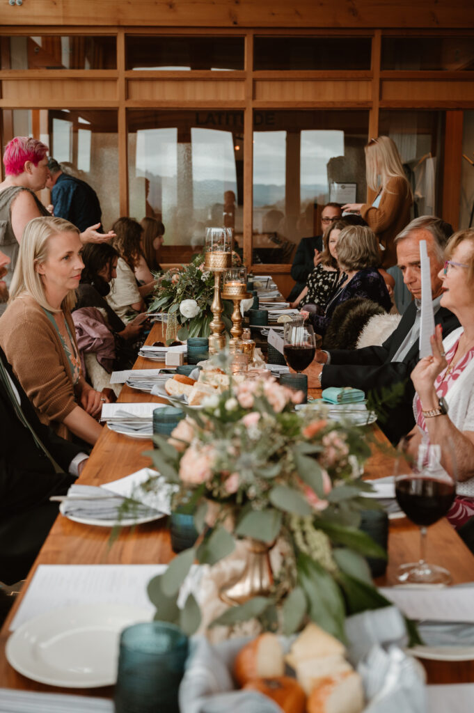 Guests sitting at the reception table at the Headlands lodge and spa for an intimate wedding celebration 