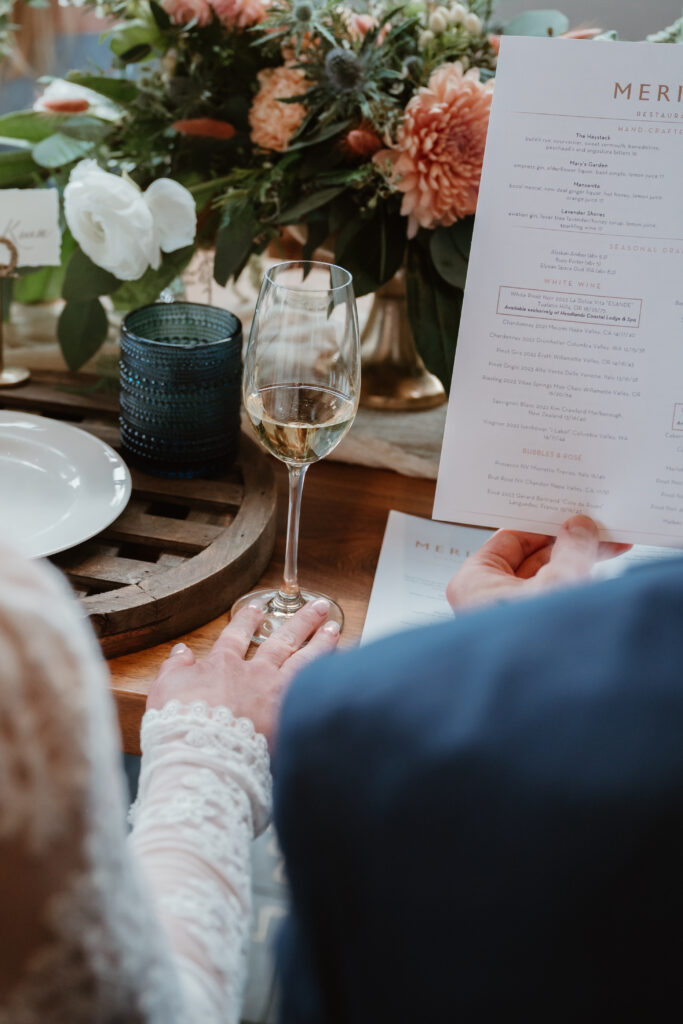 bride holding onto her wine glass at her oregon coast wedding